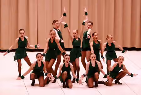 Competitive dance — A competitive dance group strikes the ending pose at the conclusion of their competition performance.