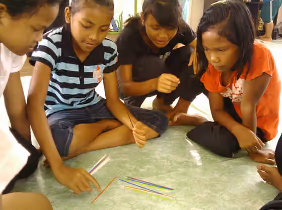 Jakun — Jakun teenagers playing pick-up sticks in the community library, Kampung Punjut, Johor, Malaysia