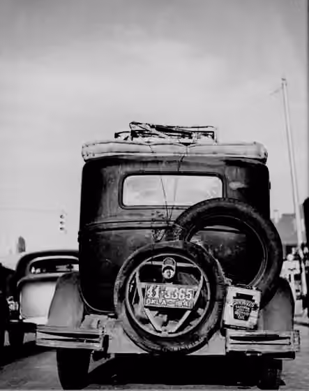 Okie — Rear view of an " Okie 's" car, passing Amarillo, Texas heading west [1]