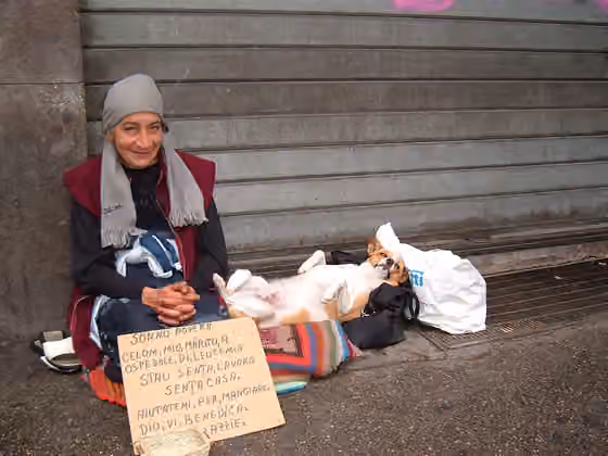 Romani people in Italy — A Roma woman with her dog in a street of Rome .