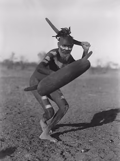 Luritja — Luritja man demonstrating method of attack with boomerang under cover of shield.