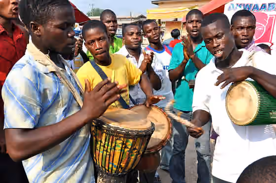 Music of the African diaspora — Men play drums at a health fair in Ghana.