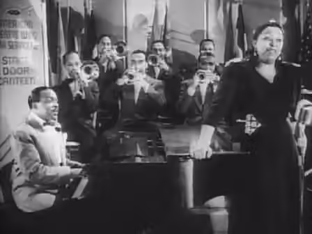 Classic female blues — Cropped screenshot of Count Basie and his band with featured vocalist Ethel Waters from the film Stage Door Canteen .