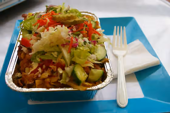 Kapsalon — Patat kapsalon (aka just Kapsalon ): french fries, grilled meat, sauces, cheese and salad.