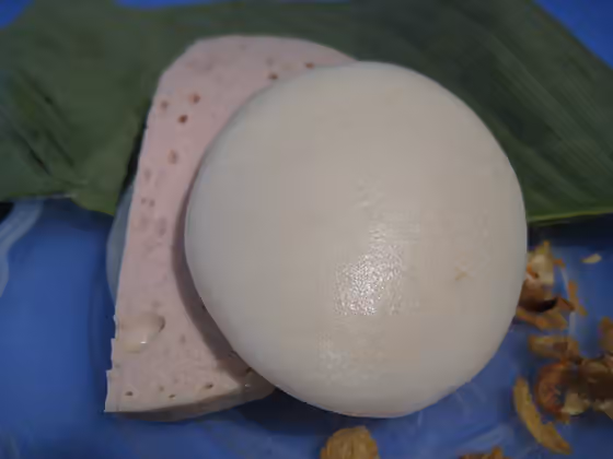 Bánh giầy — white, flat, round glutinous rice cake with tough, chewy texture served with Vietnamese sausage (Giò lụa)
