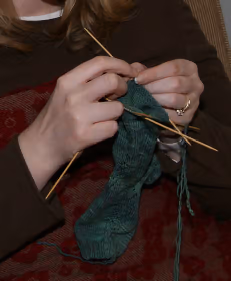 Hand knitting — Knitting stockings on double-pointed needles.
