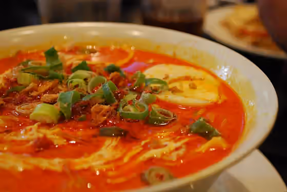 laksa — A bowl of warm chicken curry, consisted of rich creamy coconut milk and mellow lemongrass, served in Nelayan Indonesian Restaurant.