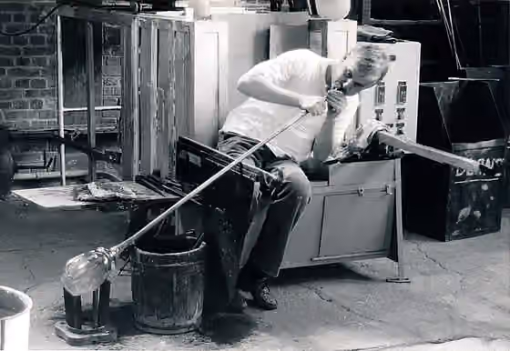 Glassblowing — The glass master Werner Garcia performing the technique of the glass blowing in the Musée-atelier du verre of Trélon (Nord), France.