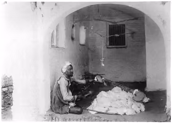 Pinjara — "Pinjāra cleaning cotton." from The Tribes and Castes of the Central Provinces of India Volume II Author: R.