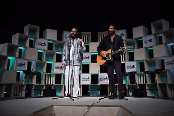 Music of São Tomé and Príncipe — 4 November 2022; Fradique Mendes Ferreira, musician, left, and Antonio Mendes Ferreira, musician, Calema, perform live on Q & A stage during day three of Web Summit 2022 at the Altice Arena in Lisbon, Portugal.