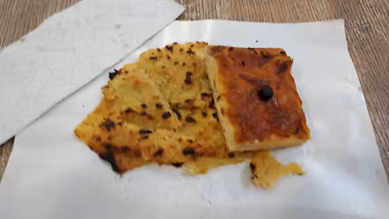 Pissaladière — Socca and Pissaladière from Chez Roger in Condamine Market, Monaco in July 2020