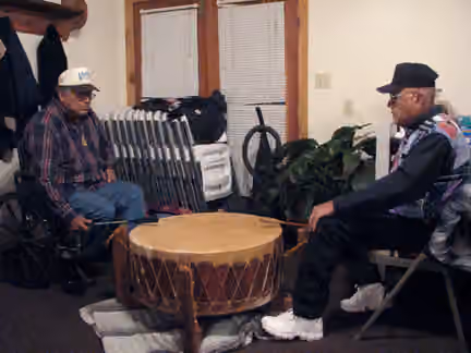 Comanche — Mac Silverhorn (grandson of Silver Horn), enrolled Comanche, drumming with friend, Redstone Baptist Church, west of Anadarko, Oklahoma