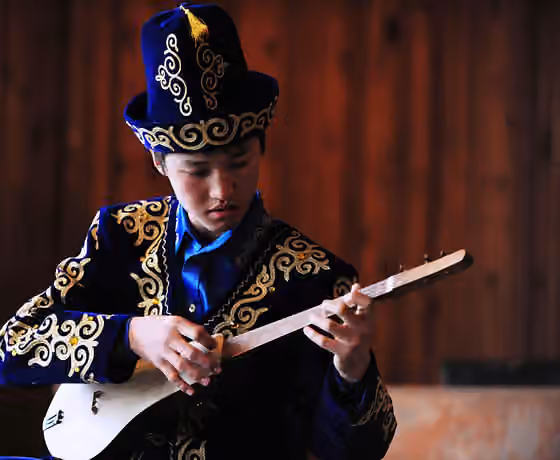 Music of Kyrgyzstan — A Kyrgyz students plays the Komuz at the Abdraev Musical Boarding School in Bishkek, Kyrgyzstan, Jan.
