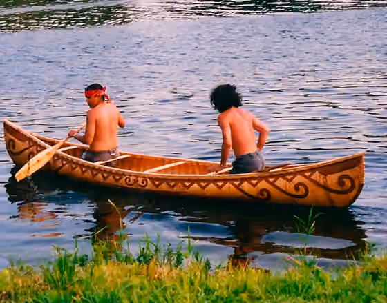 Passamaquoddy — Two Peskotomuhkati men in a birch bark canoe.