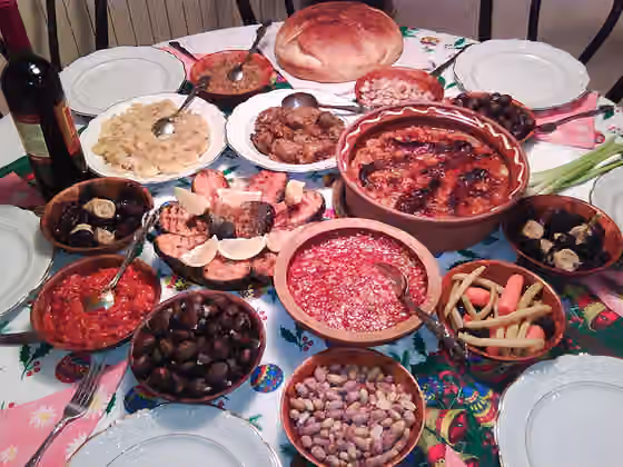Macedonian cuisine — Macedonian Christmas Eve (Badnik) Dinner Table: Fish, Beans, Paprika salads, Sarma, Dates, Figs, Chestnuts and the Bread loaf with concealed coin.