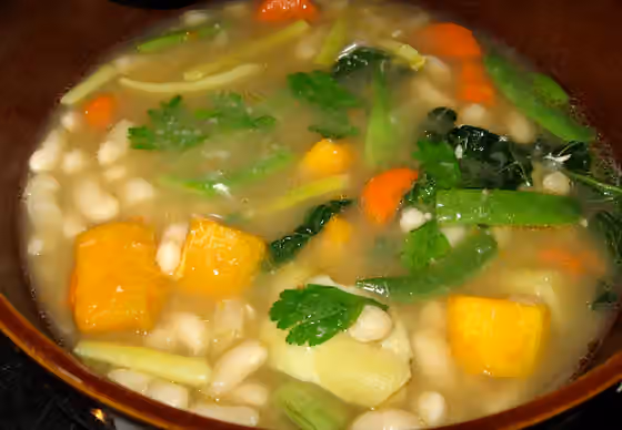 Garbure — soup featuring cannelini beans, haricots verts, savoy cabbage sweet potatoes and butternut squash