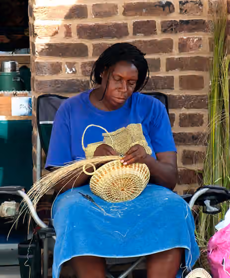 Gullah — A gullah woman makes a sweetgrass basket in Charleston's City Market