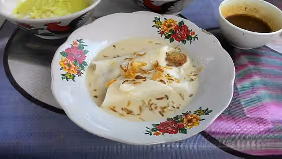 Burgo — Burgo, thin layer of folded rice cake, served in spiced white coconut milk soup flavoured with bits of fish, sprinkled with crispy fried shallot.
