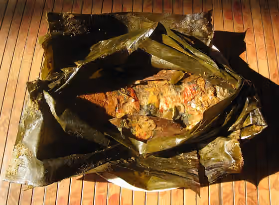pepes — Pais lauk mas (pepes ikan mas), a carp fish in spices and herbs cooked in banana leaf package.
