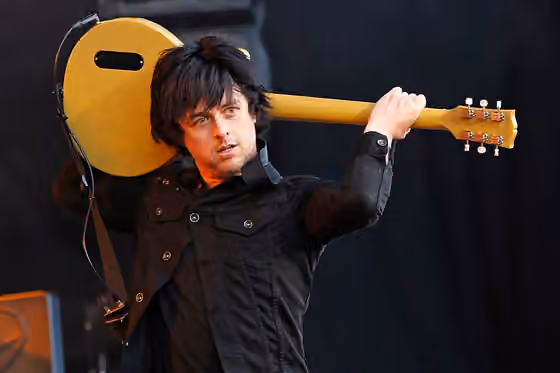 pop punk — Billie Joe Armstrong , singer and guitarist of Green Day , stands on the Center Stage of Rock im Park-Festival 2013 .