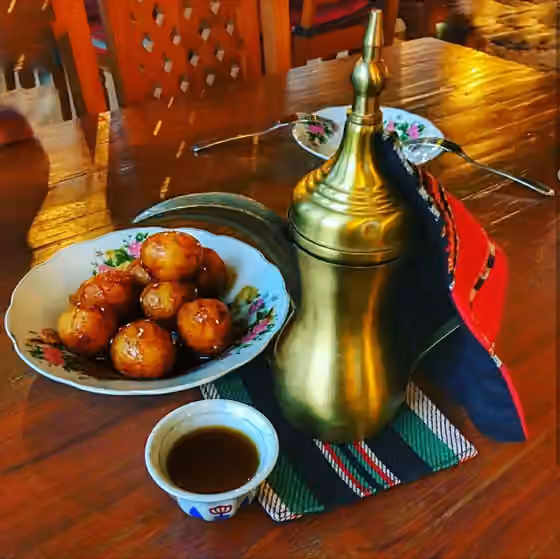 Masakan Uni Emirat Arab — Arabic Coffee with Lugaimat; traditional Emirati sweets.