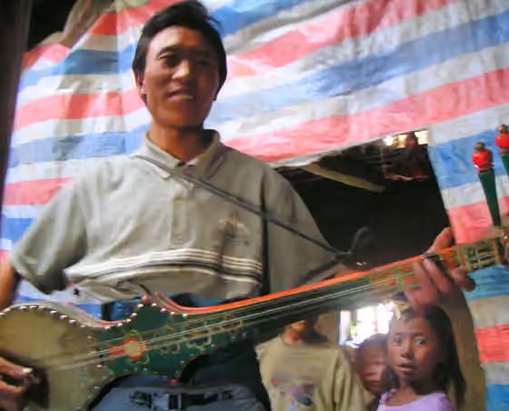 Rigsar — Tibetan dranyen player.