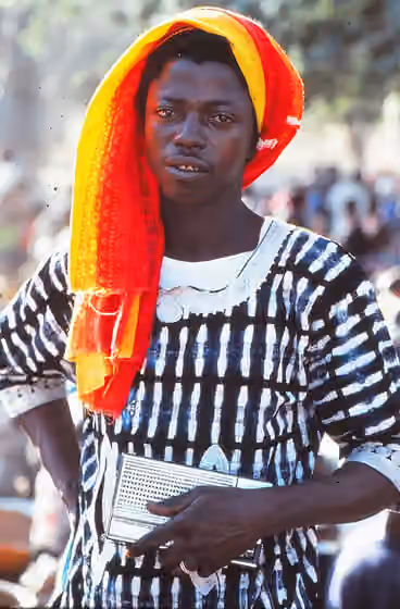 Dogon — Young man just returned from Abidjan, with his radio, Tireli, Mali 1985