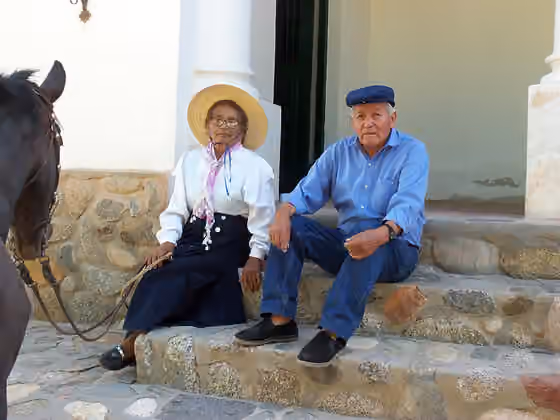 Mestizo Argentines — Photograph of a female alferez (alfereza) whith her horse and a man in Molinos (Salta Province, Argentina).