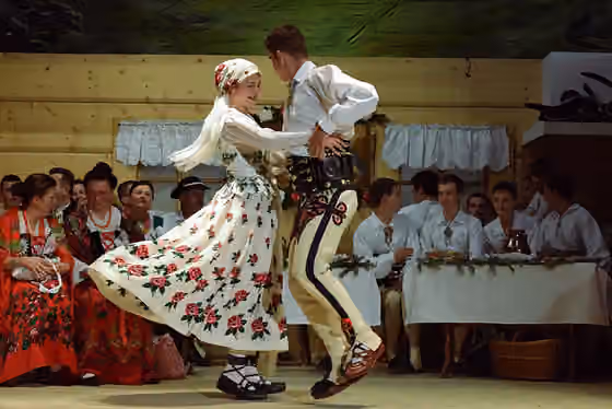 Folk costumes of Podhale — "Gorals' Wedding" folk performance at Dom Ludowy Theatre in Bukowina Tatrzańska - bride and groom dancing