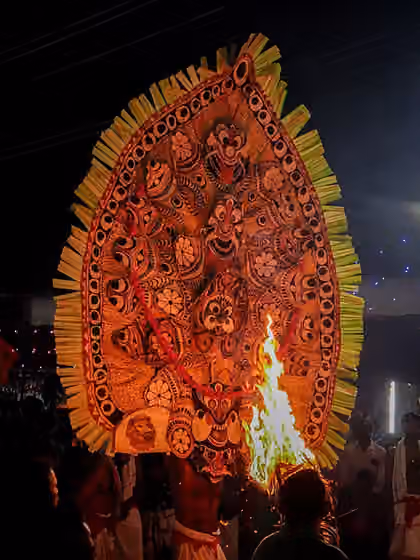 Padayani — These Kolam are representations of spiritual forces or divine characters, and are depicted with terrifying and spectacular face masks and head gear, painted in vivid colours like deep red and black, using natural powders.