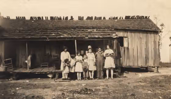 Alabama Cajans — Cajan children standing infront of a Cajan home near Calvert, Alabama, published in volume one of the Alabama Historical Quarterly, Spring 1930.