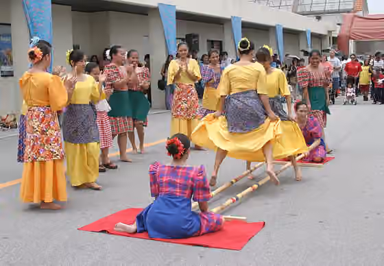 Tinikling — Members from the Philippine Cultural Dancers group perform a traditional dance ( tinikling ) during the Asian Pacific Heritage Month celebration May 26 at the Kadena Air Base, Japan, exchange parking lot.