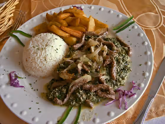 Ndolé — (Google Translate) The Cameroonian ndolé is a dish prepared with green leaves of Vernonia cooked several times with water to make them lose their bitterness and then mixed with a paste of raw peanuts and crushed spices.