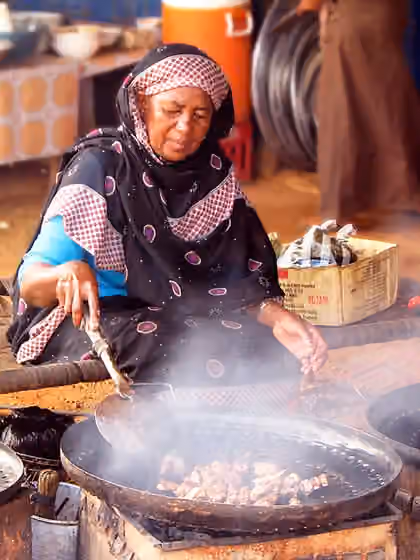Sudanese cuisine — Woman preparing food, Sudan .