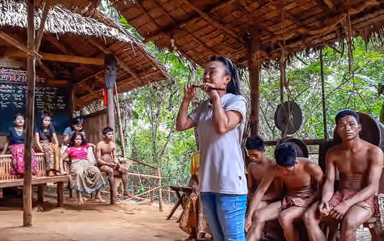 Orang Palawan — Tour guide demonstrating the tribe's musical instrument