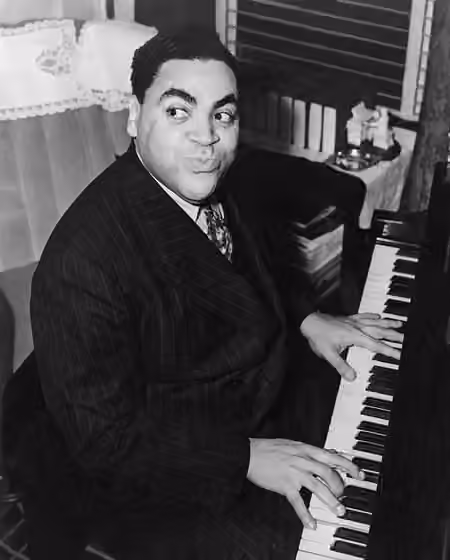 Stride (music) — Fats Waller, three-quarter length portrait, seated at piano, facing front.