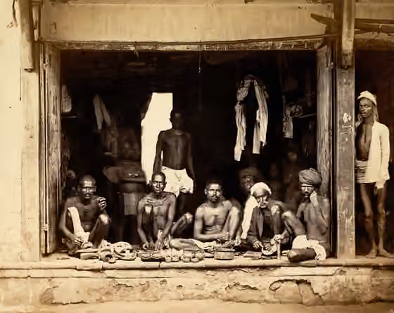 Chakkiliyan (Sakkiliyar) — Photograph of country shoe makers, probably from Western India, taken by an unknown photographer in c.