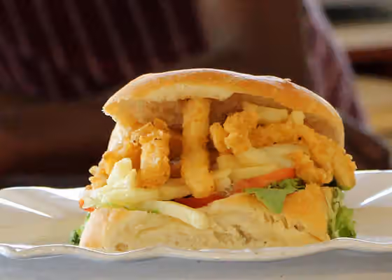 Gatsby — Gatsby sandwich filled with calamari and chips for sale at The Fish Stop stall at Root44 Market, Stellenbosch, South Africa