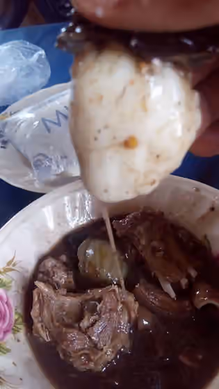 Okoho — Okoho Soup eaten with goat meat and Pounded yam by an Idoma man