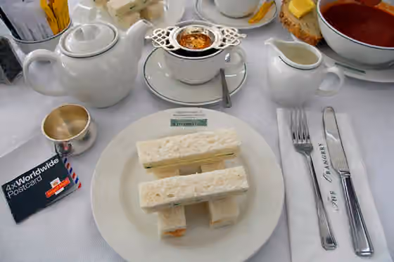 Roti lapis mentimun — Cucumber and cream cheese sandwiches with tea as served at The Orangery at Kensington Palace in London .