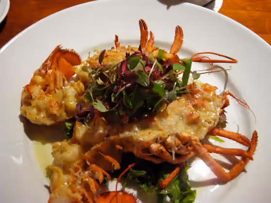 Lobster Thermidor — Lobster Thermidor is a French dish consisting of a creamy mixture of cooked lobster meat, egg yolks, and cognac or brandy, stuffed into a lobster shell, and optionally served with an oven-browned cheese crust, typically Gruyère.
