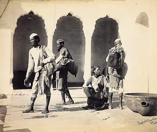Bhishti — "Bheesties" - This photograph is part of a series taken by the firm of Shepherd and Robertson for a book entitled 'The People of India' by Forbes Watson, published in 1868.