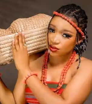 Bassa people (Nigeria) — A Bassa lady dressed in the Ogboro Attire, carrying load on her shoulder