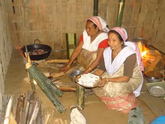 Chutia people — Women of Chutia tribe preparing pithas during Bihu