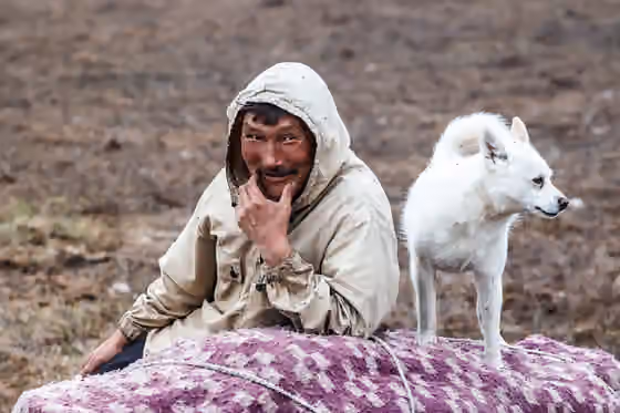 Orang Selkup — A Selkup man with his dog.