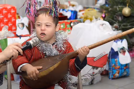 Music of Turkmenistan — A Turkmen boy plays an instrument at a holiday party.