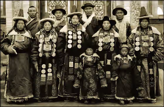 Yugur — This is probably a Yugur family, looking at their hat and ornaments, see the modern version here : [ 1 ] [ 2 ] [ 3 ] [ 4 ] .Yugur are descendant of Mongols and Ouigours, leaving in Gansu, near Lanzhou.