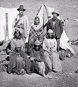 Modoc people — "Winema or Tobey Riddle, a Modoc, standing between an agent and her husband Frank (on her left), with four Modoc women in front." American Indian Select List number 72.