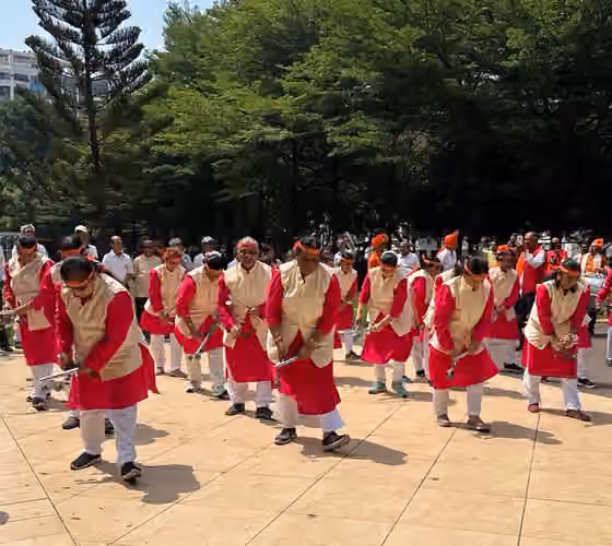 Lezim — Group of dancers from Maharashtra, India in a formation performing a local folk dance with Lezim (cymbal like musical instruments).