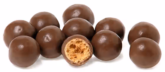 Maltesers — A pile of Maltesers candies and one split in half.